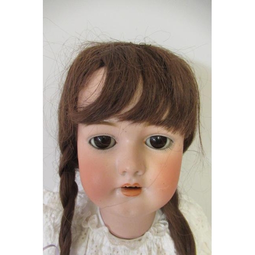 68 - A Simon & Halbig bisque socket head doll, with brown glass sleeping eyes, open mouth and teeth, pier... 