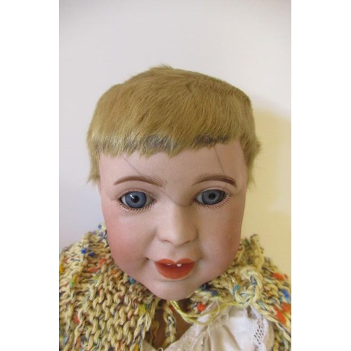 7 - An SFBJ bisque head character doll, with blue glass sleeping eyes, open mouth, flock hair and compos... 