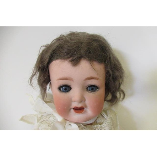 75 - A Heubach Koppelsdorf bisque socket head doll, with blue glass sleeping eyes, open mouth, teeth, fix... 