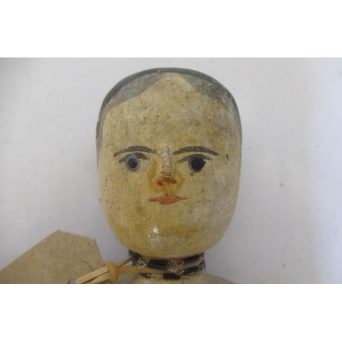 83 - An antique peg doll, with painted features and hinged joints (Est. plus 21% premium inc. VAT)