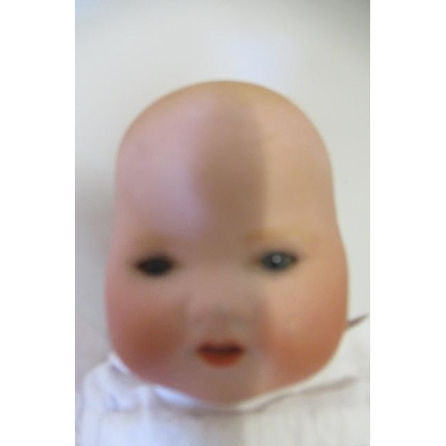 85 - A Heubach Koppelsdorf bisque socket head baby doll, with blue glass sleeping eyes, moulded hair, clo... 