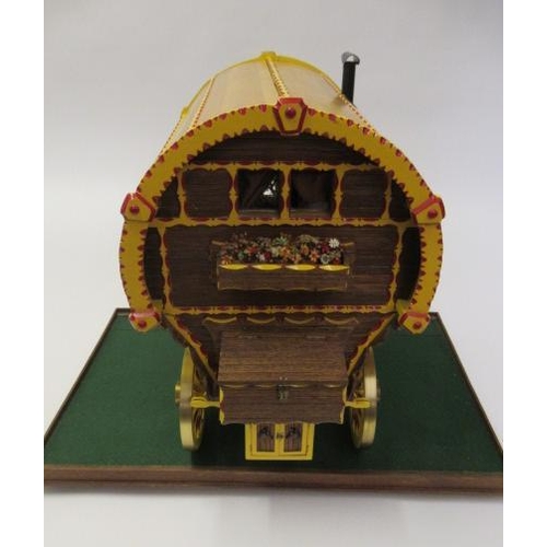 909 - A well made model of a horse drawn gypsy caravan, wood construction, fine decoration with detailed i... 