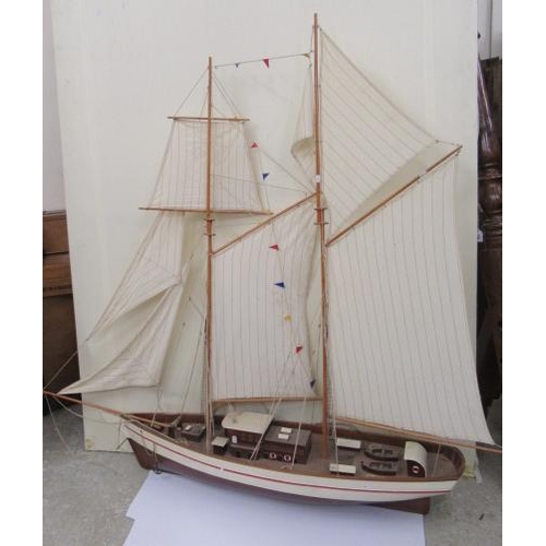 924 - A large model of two mast sail boat of wooden construction, finished in white with rigging and cloth... 