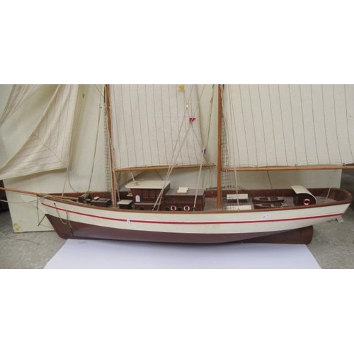 924 - A large model of two mast sail boat of wooden construction, finished in white with rigging and cloth... 