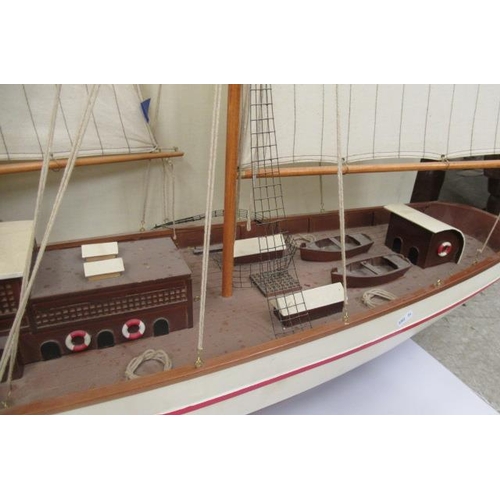 924 - A large model of two mast sail boat of wooden construction, finished in white with rigging and cloth... 