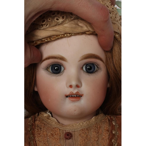 11 - A  French Eden Bebe bisque socket head doll, with blue glass paperweight eyes, open mouth, six top t... 