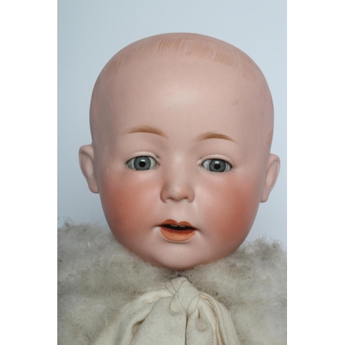 123 - A German bisque head boy character doll, possibly Gebruder Knoch, with blue glass sleeping eyes, ope... 