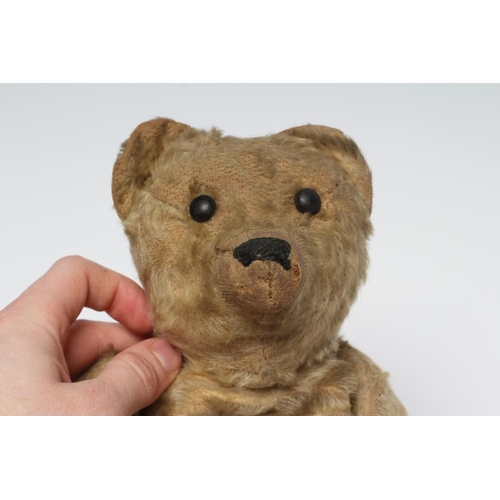 151 - An early German teddy, straw filled, with light orange plush, later sewn nose, button eyes, leather ... 