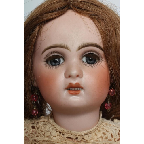 23 - A Tete Jumeau bisque socket head doll, with blue glass sleeping eyes, open mouth, six top teeth, pie... 