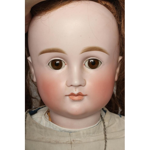 99 - A French bisque socket head doll, with brown glass sleeping eyes, closed mouth, composition jointed ... 