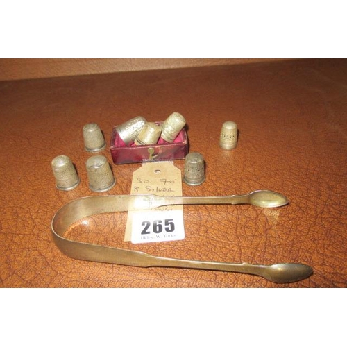 265 - EIGHT SILVER THIMBLES AND A PAIR OF SUGAR TONGS