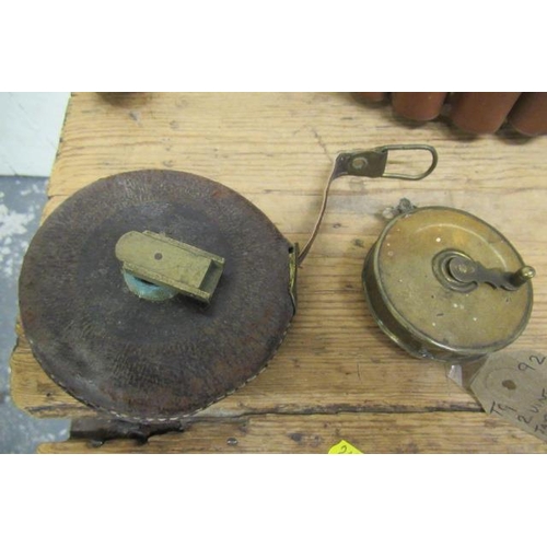 3 - TWO VINTAGE TAPE MEASURES