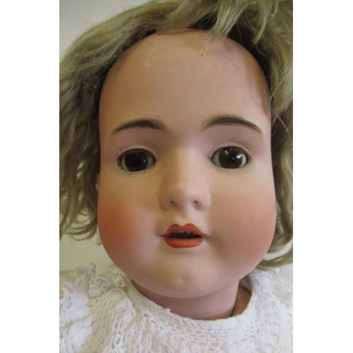 1 - A bisque socket head doll, comprising a Bruno Schmidt girl, with brown glass sleeping eyes, open mou... 