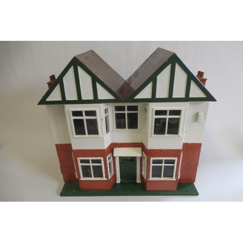 113 - A scratch built doll's house and contents, 1940s, with twin peak roof, bay windows and single hinge ... 