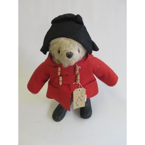 115 - A Paddington Bear, with amber eyes, red felt coat, black felt hat, PB black boots and label, 22