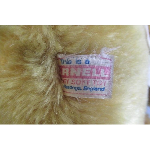 116 - A Farnell growling teddy bear, with amber eyes, orange plush, jointed body, fabric pads and label to... 