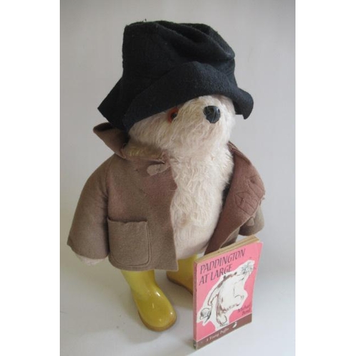 145 - A Paddington bear, with brown coat, black hat and yellow dunlop boots, together with a Puffin editio... 