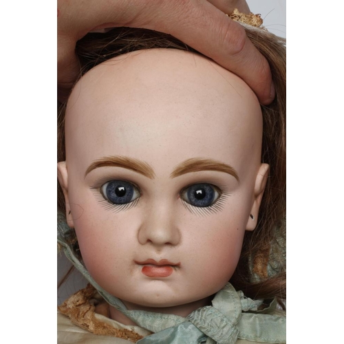 20 - A Tete Jumeau bisque socket head doll, with blue glass paperweight fixed eyes, closed mouth, brown w... 