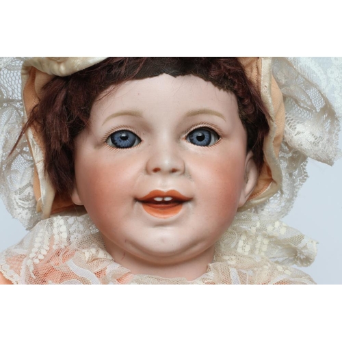 28 - An SFBJ bisque socket head character doll, with blue glass sleeping eyes, laughing mouth moulded ope... 