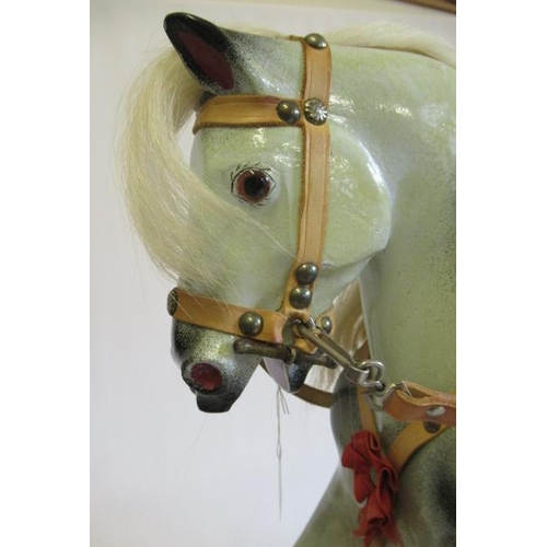 284 - A Triang rocking horse, of carved wood construction, with amber inset eyes, dappled grey paint, leat... 