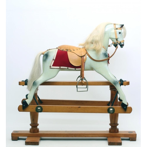 284 - A Triang rocking horse, of carved wood construction, with amber inset eyes, dappled grey paint, leat... 