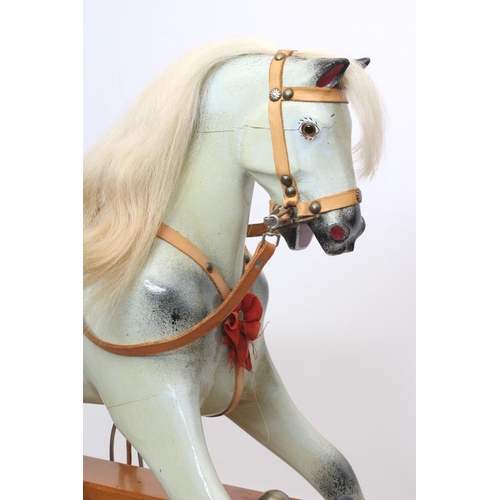 284 - A Triang rocking horse, of carved wood construction, with amber inset eyes, dappled grey paint, leat... 