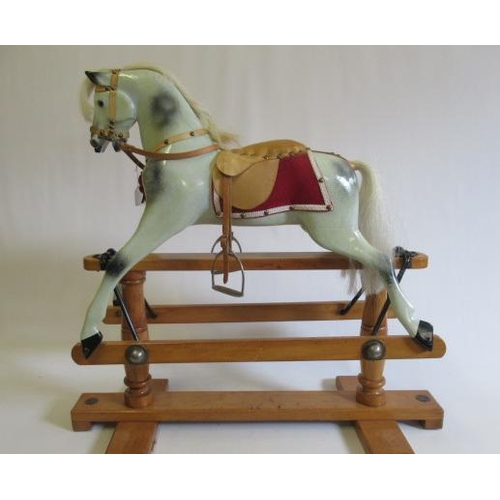 284 - A Triang rocking horse, of carved wood construction, with amber inset eyes, dappled grey paint, leat... 