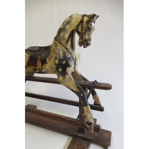 284 - A Triang rocking horse, of carved wood construction, with amber inset eyes, dappled grey paint, leat... 