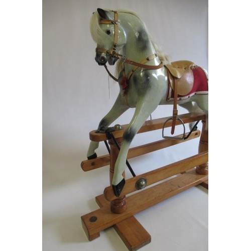 284 - A Triang rocking horse, of carved wood construction, with amber inset eyes, dappled grey paint, leat... 