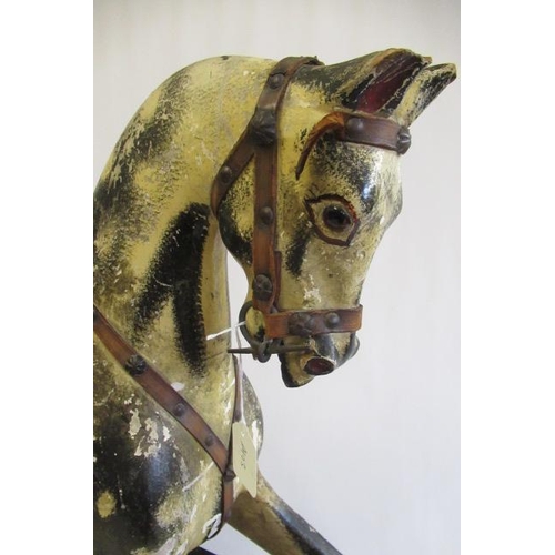 285 - An antique rocking horse, or carved wood construction, amber glass eyes, dappled grey paint, velvet ... 