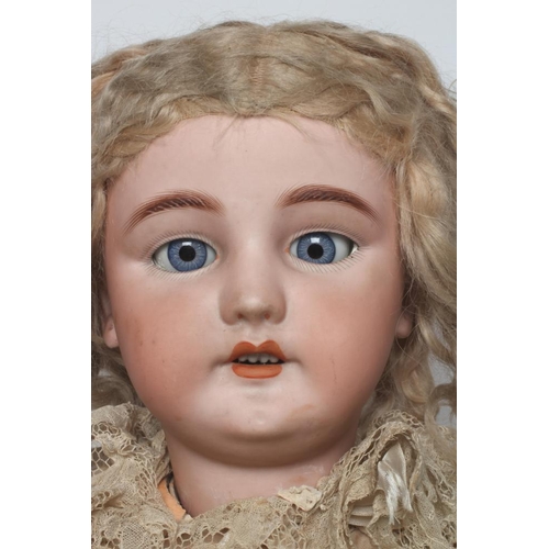 30 - A large Simon & Halbig bisque socket head doll, with blue glass paperweight sleeping eyes, moulded e... 