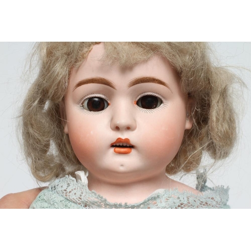 39 - A possibly Kestner shoulder head doll, with brown glass fixed eyes, open mouth, six top teeth, pierc... 