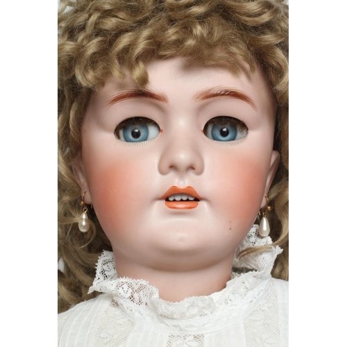 82 - A large German bisque socket head doll, with blue glass sleeping eyes, open mouth, teeth, pierced ea... 