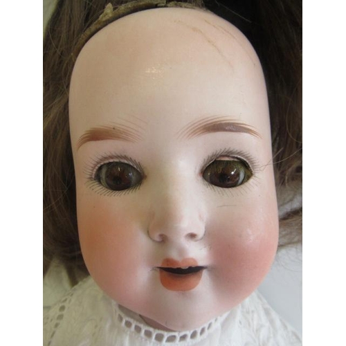 40 - A Schoenau & Hoffmeister bisque socket head doll, with brown glass sleeping eyes, open mouth and top... 