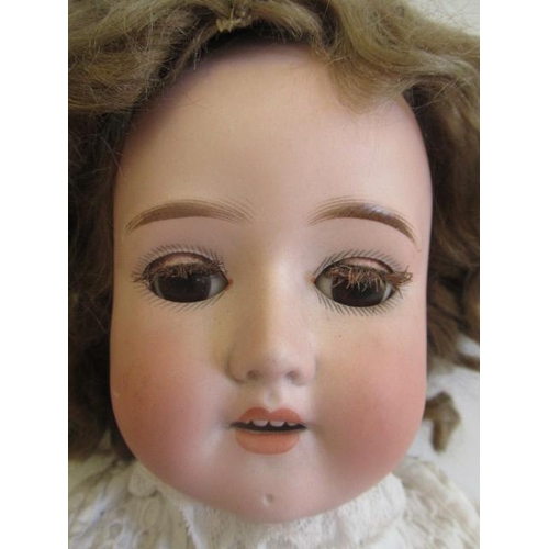 42 - A Schoenau & Hoffmeister bisque socket head doll, with brown glass sleeping eyes, open mouth and top... 