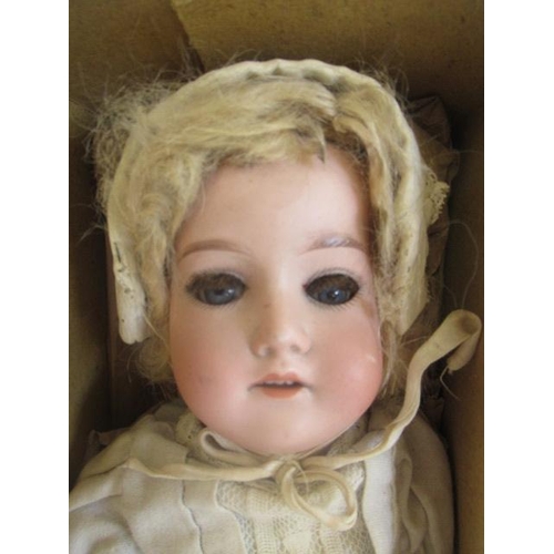 67 - An Armand Marseille bisque socket head doll, with blue glass fixed eyes, open mouth, teeth, blond wi... 