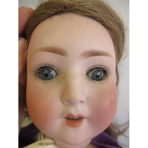 71 - A Simon & Halbig bisque socket head doll, with blue glass sleeping eyes, open mouth, teeth, brown wi... 