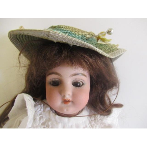 75 - A Simon & Halbig bisque socket head doll, with brown glass sleeping eyes, open mouth, teeth, pierced... 