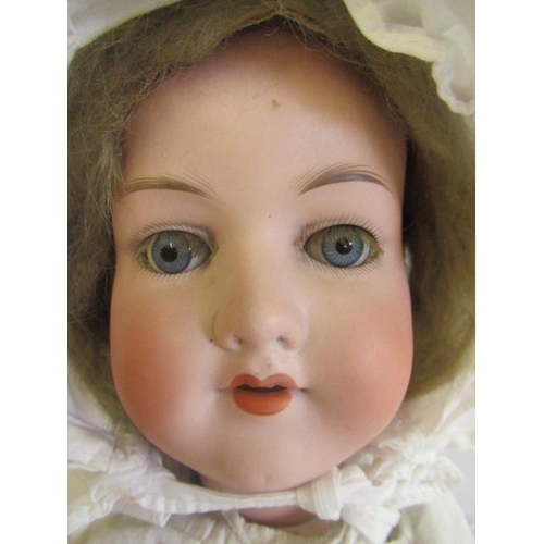 88 - An Armand Marseille bisque socket head doll, blue glass sleeping eyes, open mouth, teeth, blond wig,... 