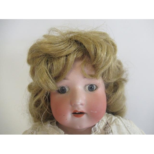 93 - A Heubach bisque shoulder head doll, with blue glass fixed eyes, open mouth, teeth, blond wig, kid b... 