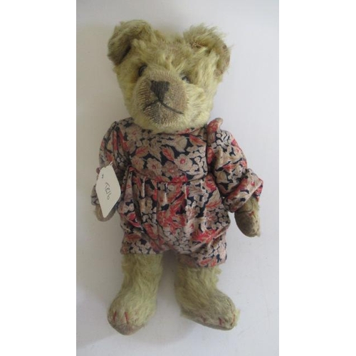 136 - An early English teddy, with clear glass eyes, sewn nose, light orange plush, red sewn finger and to... 