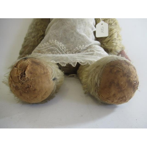 138 - A pre-war teddy, with clear glass eyes, sewn nose, light orange plush, straw filled jointed body, lo... 