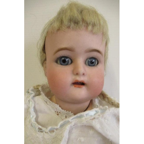 29 - A Kammer & Reinhardt bisque socket head doll, with blue glass sleeping eyes, open mouth, applied top... 