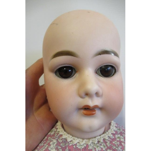 3 - An Armand Marseille bisque socket head doll, with brown glass sleeping eyes, open mouth, top teeth, ... 