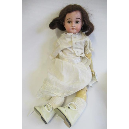 52 - An Armand Marseille bisque socket head doll, with brown glass fixed eyes, open mouth, teeth, brown w... 