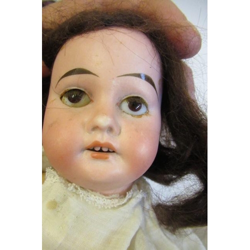 52 - An Armand Marseille bisque socket head doll, with brown glass fixed eyes, open mouth, teeth, brown w... 