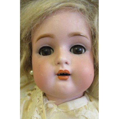 61 - A Kammer & Reinhardt bisque socket head doll, with brown glass sleeping eyes, open mouth, teeth, pie... 