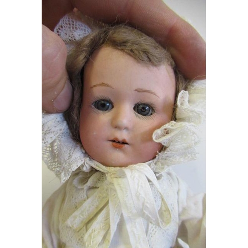 63 - A Heaubach bisque socket head doll, with blue glass sleeping eyes, open mouth, teeth, brown wig, ben... 