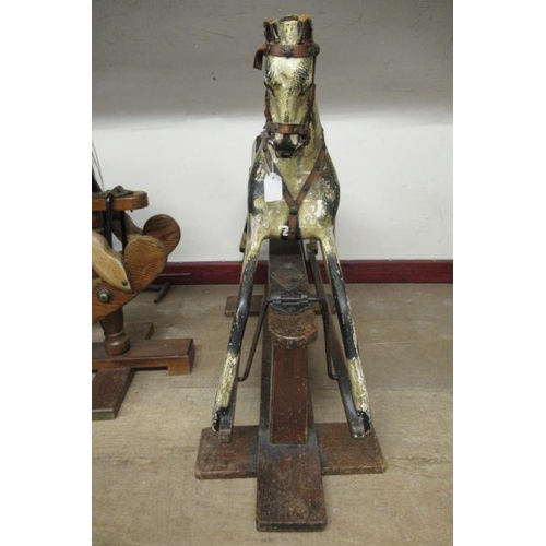 285 - An antique rocking horse, or carved wood construction, amber glass eyes, dappled grey paint, velvet ... 