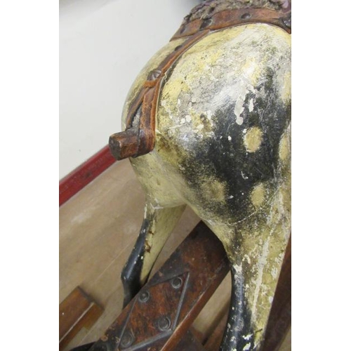 285 - An antique rocking horse, or carved wood construction, amber glass eyes, dappled grey paint, velvet ... 